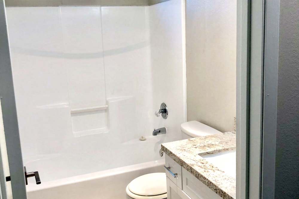 Bathroom with tub and shower combo at The Indie Glendale Collection in Glendale, California