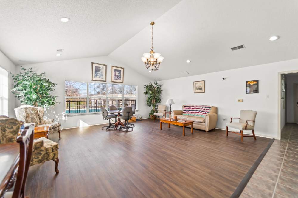 Community seating area with couch and large windows at Callaway Village Apartments in Fulton, Missouri