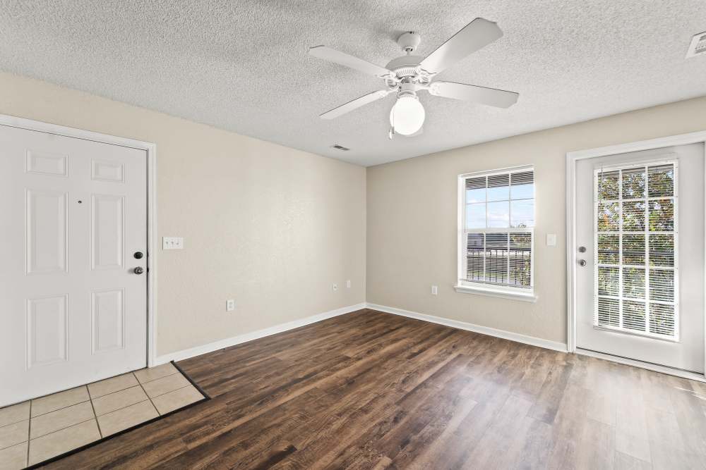Unfurnished bedroom with wooden flooring access to patio at Callaway Village Apartments in Fulton, Missouri