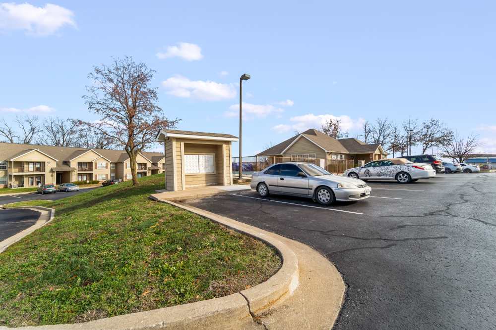 Apartment view with green lawn and parked cars at Callaway Village Apartments in Fulton, Missouri