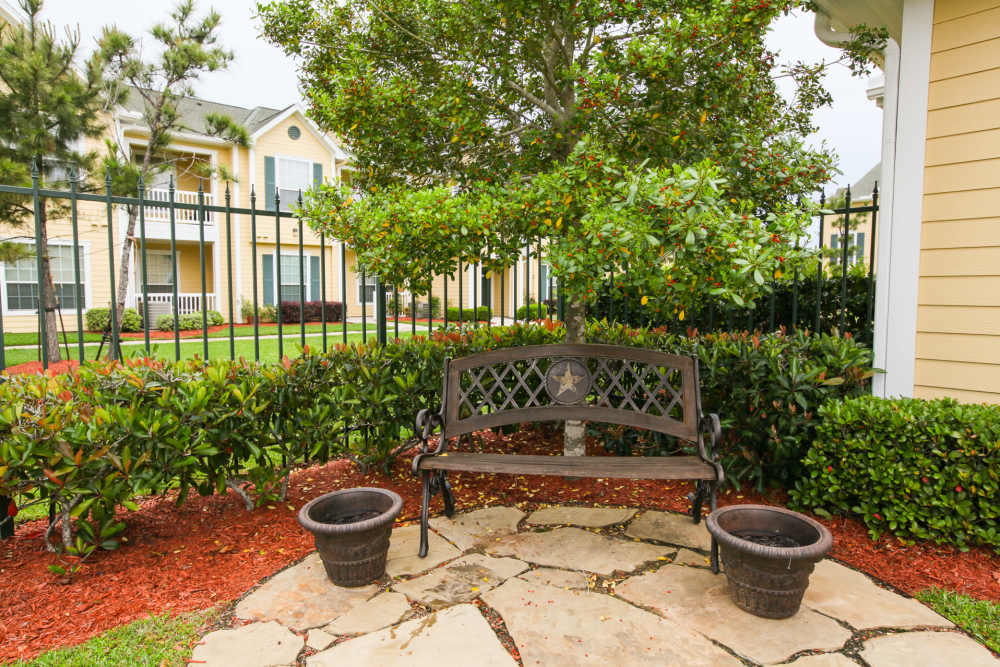 Charming garden seating area surrounded by lush greenery at Country Lane in Angleton, Texas