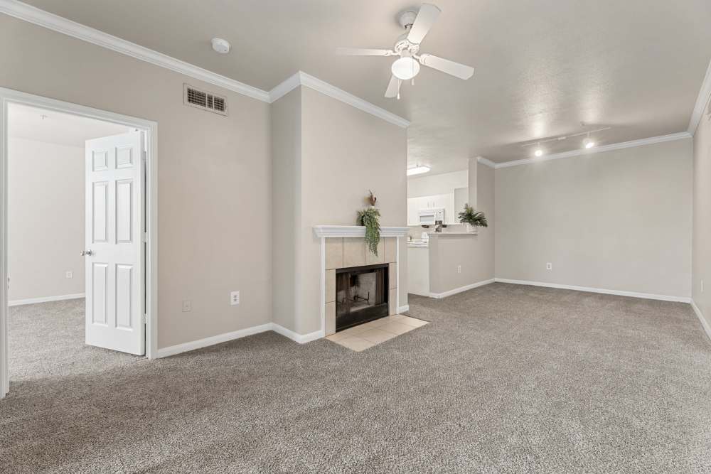 Living area with fireplace and dining area view at Columbia Greens in Houston, Texas