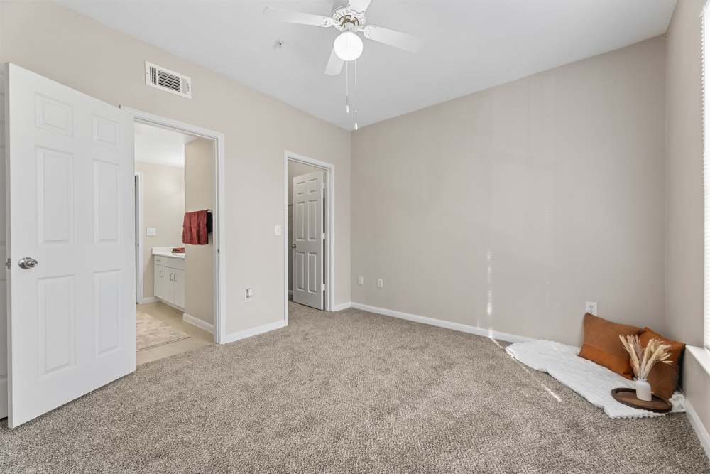 Bedroom with carpet flooring and attached bathroom at Columbia Greens in Houston, Texas