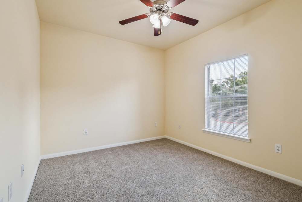 Bedroom with carpet flooring and window at Autumn Pines in Humble, Texas