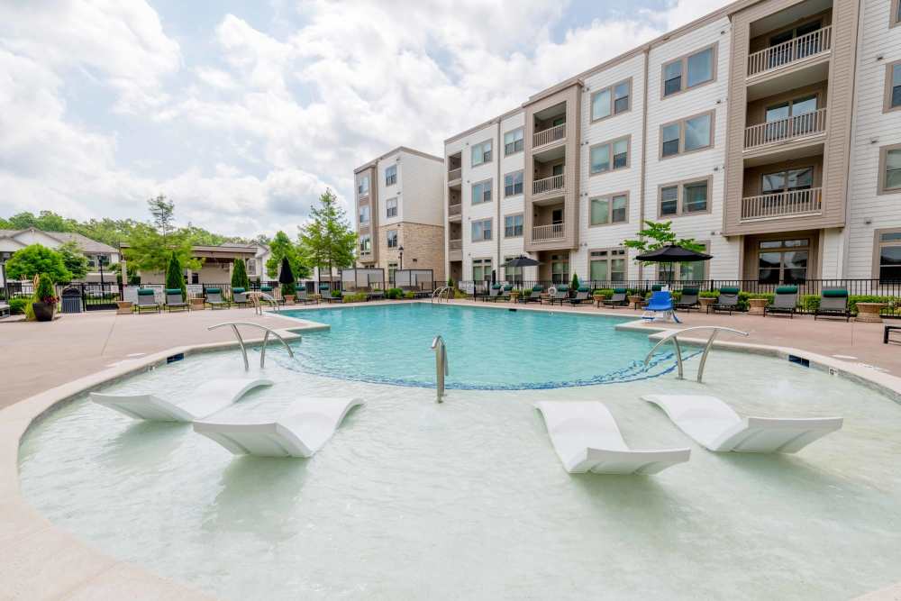pool area with chairs and in pool lounge chairs   The Reserve at Patterson Place  durham NC luxury apartments