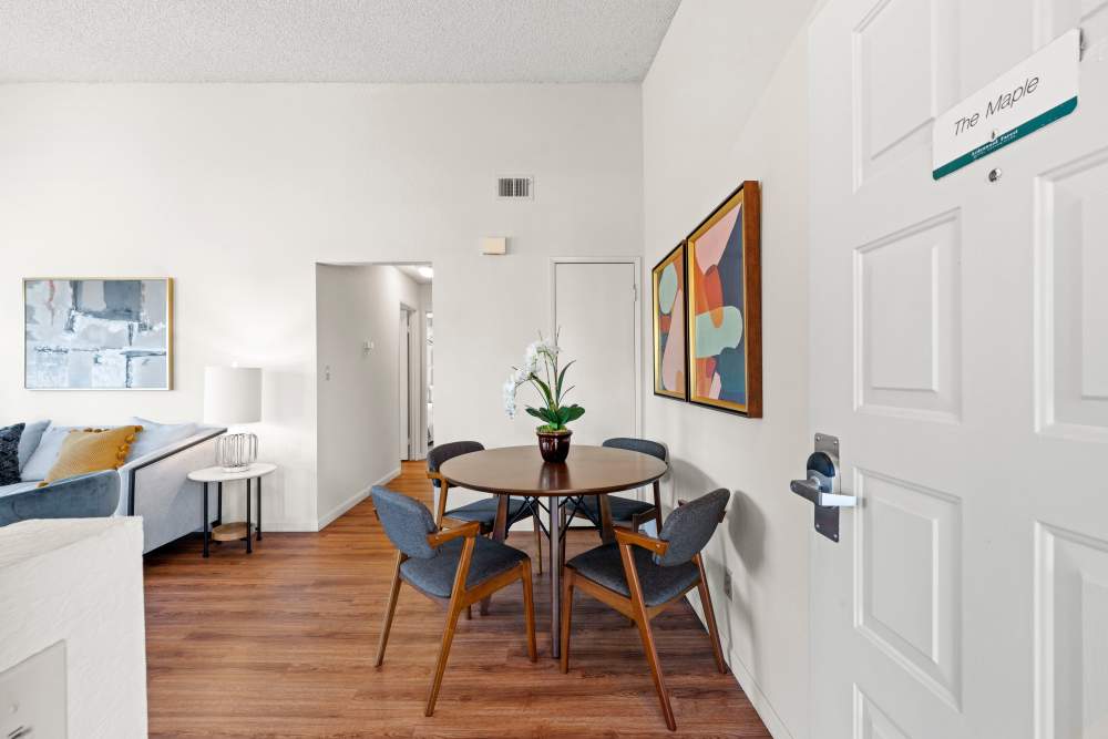 Dining table with connecting living room at Ardenwood Forest Rental Condominiums in Fremont, California