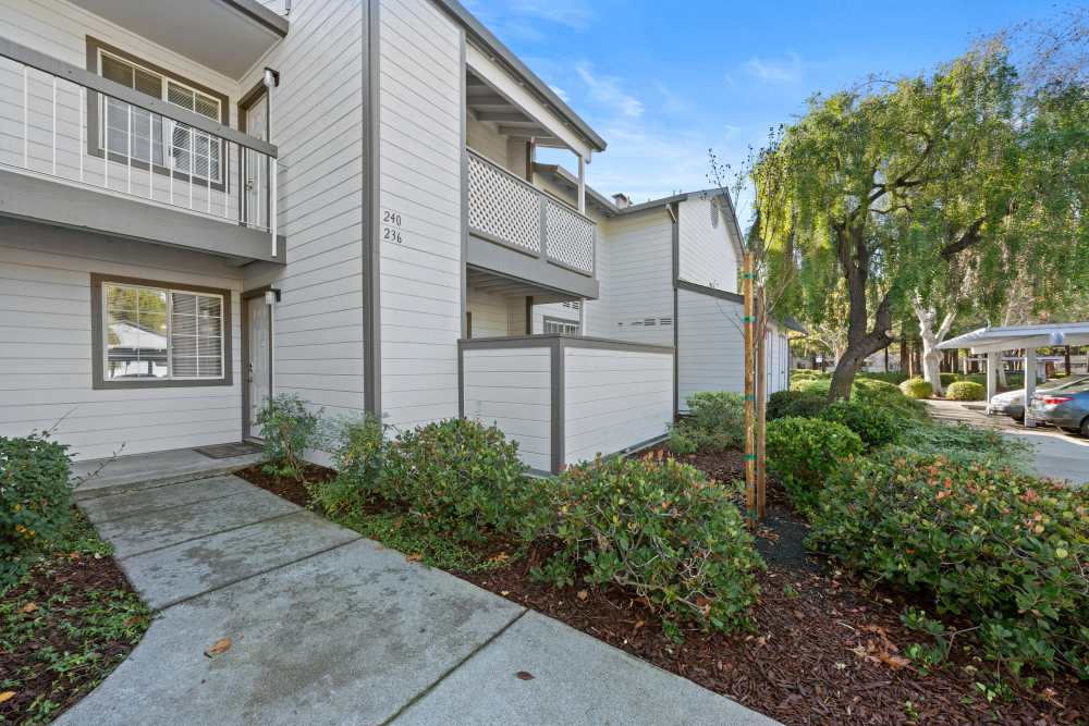 Community building exterior with sidewalk  at Country Brook Rental Condominiums in San Ramon, California