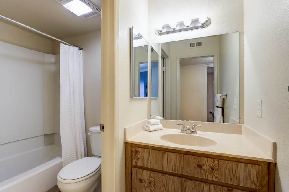 Bathroom with frameless vanity mirror at Country Brook Rental Condominiums in San Ramon, California