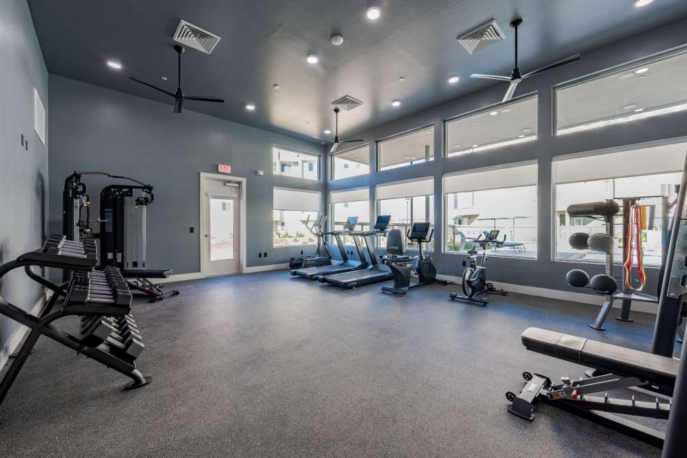 Community gym with cardio machines and free weights at Overland Flats in Maricopa, Arizona