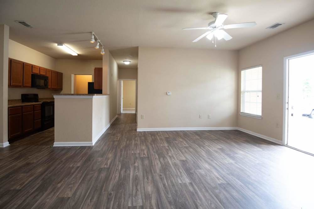Open-concept living room and kitchen with wood-style flooring at Preserve at Lauren's Creek in Aiken,South Carolina