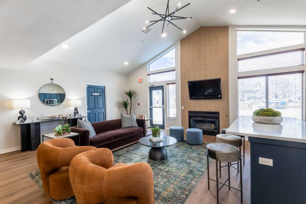 Clubhouse with fireplace and stylish furniture at Pavilions at Silver Sage in Fort Collins, Colorado
