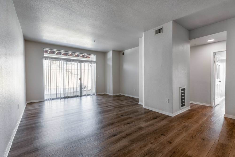Spacious living area with wood-style flooring at Pavilions at Silver Sage in Fort Collins, Colorado