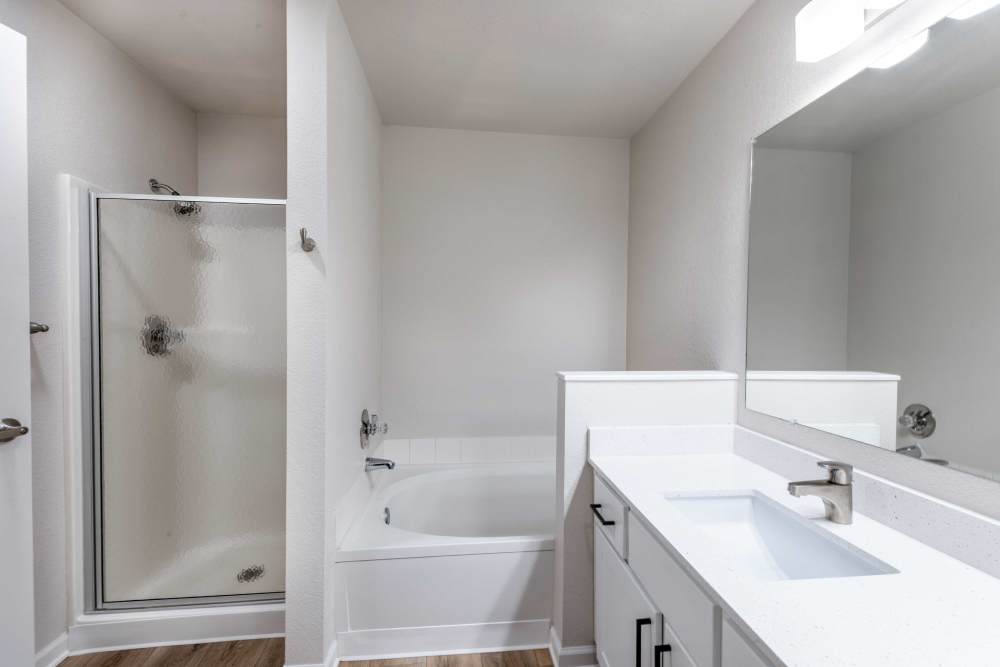 Bathroom with shower, bathtub, and vanity at Pavilions at Silver Sage in Fort Collins, Colorado