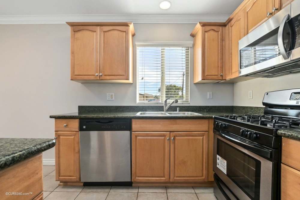 Kitchen with stainless-steel appliances at Bostonia in El Cajon, California
