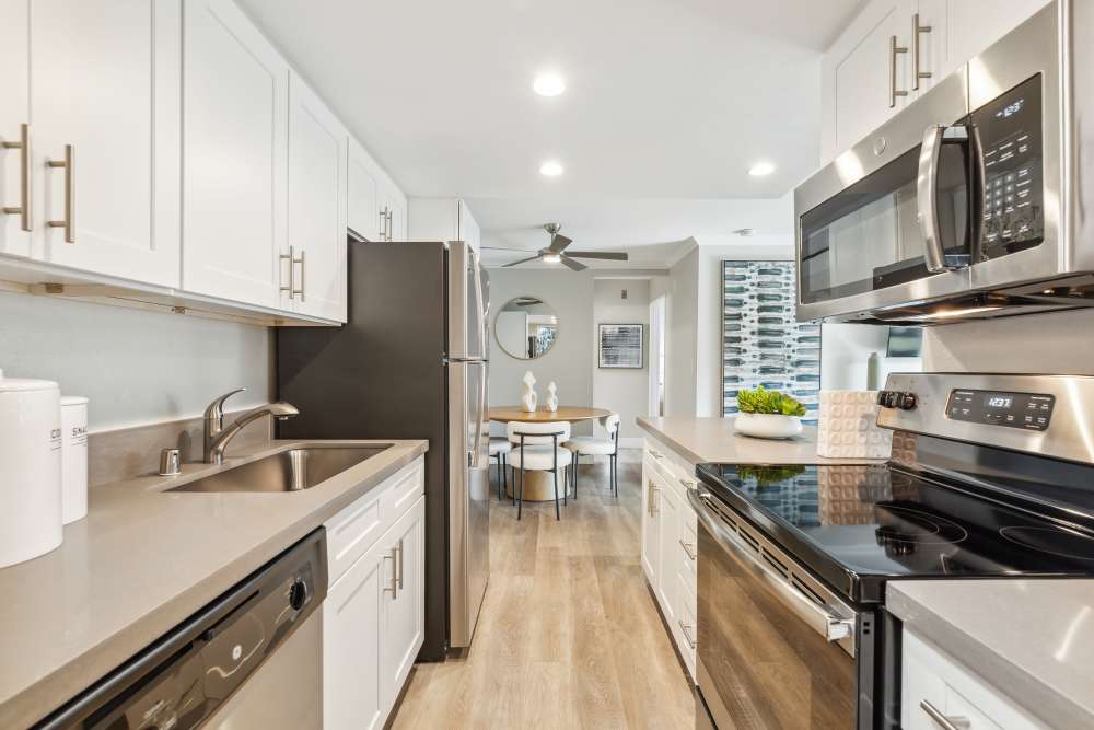 Modern kitchen with stainless steel appliances at Sofi at Wood Ranch in Simi Valley, California