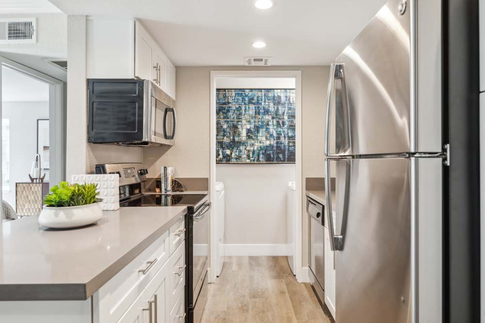 Modern kitchen with stainless steel appliances at Sofi at Wood Ranch in Simi Valley, California