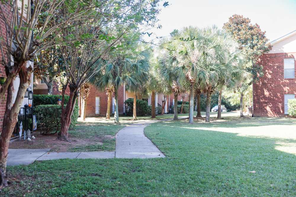 Open lawn with path and greenery all around at Annandale Park in Robertsdale, Alabama