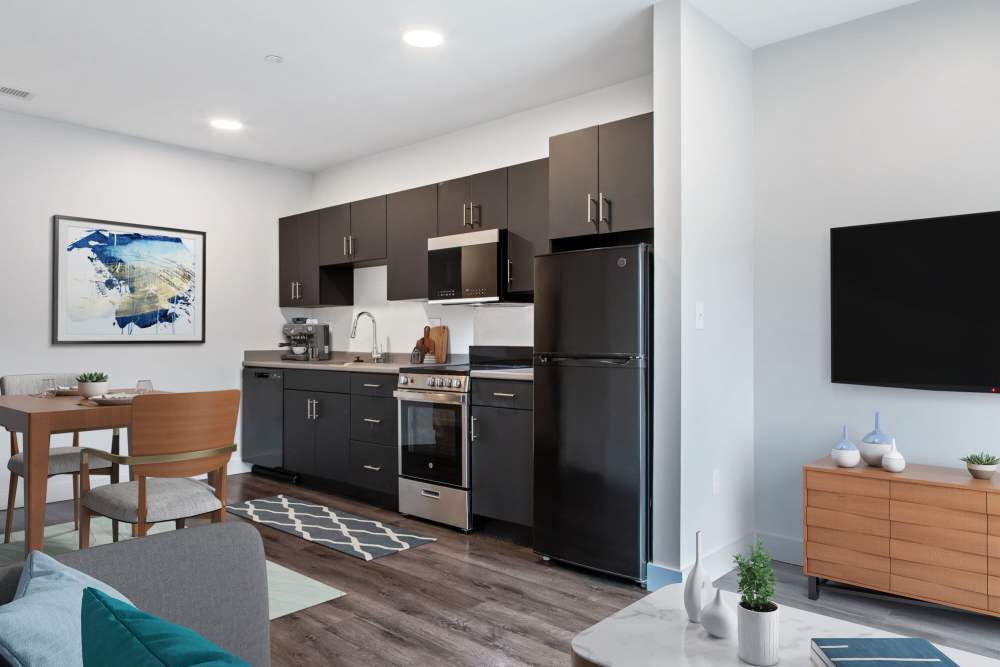 View from living room and access to modern kitchen and dining area at The Lighthouses in Salem, Massachusetts