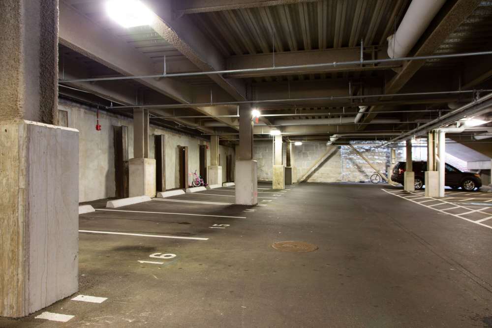 Indoor parking garage with concrete pillars, and parked bicycles at The Lighthouses in Salem, Massachusetts