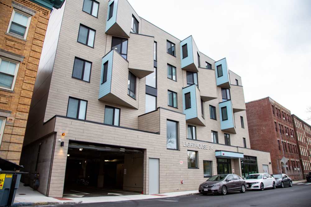 Apartment building named Lighthouse 34 with boxy window structures and garage entrance at The Lighthouses in Salem, Massachusetts