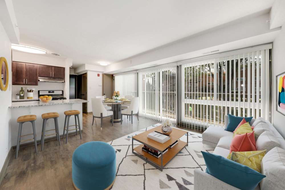 Sunlit living room with modern kitchen and stylish dining area at Parkside Landing Apartments in Rockville, Maryland