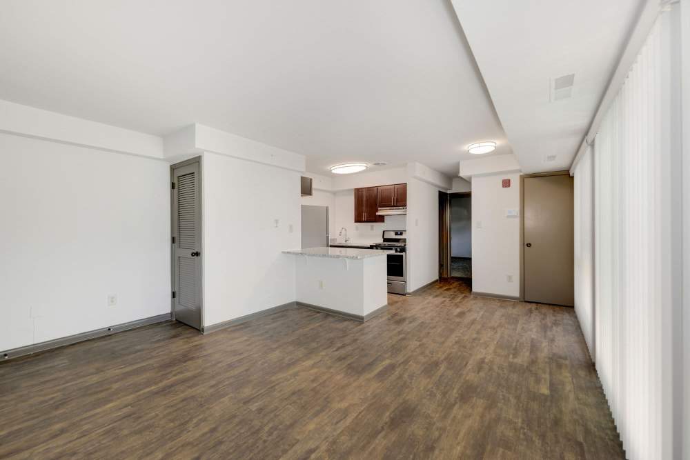 Spacious living room with modern kitchen and natural light at Parkside Landing Apartments in Rockville, Maryland