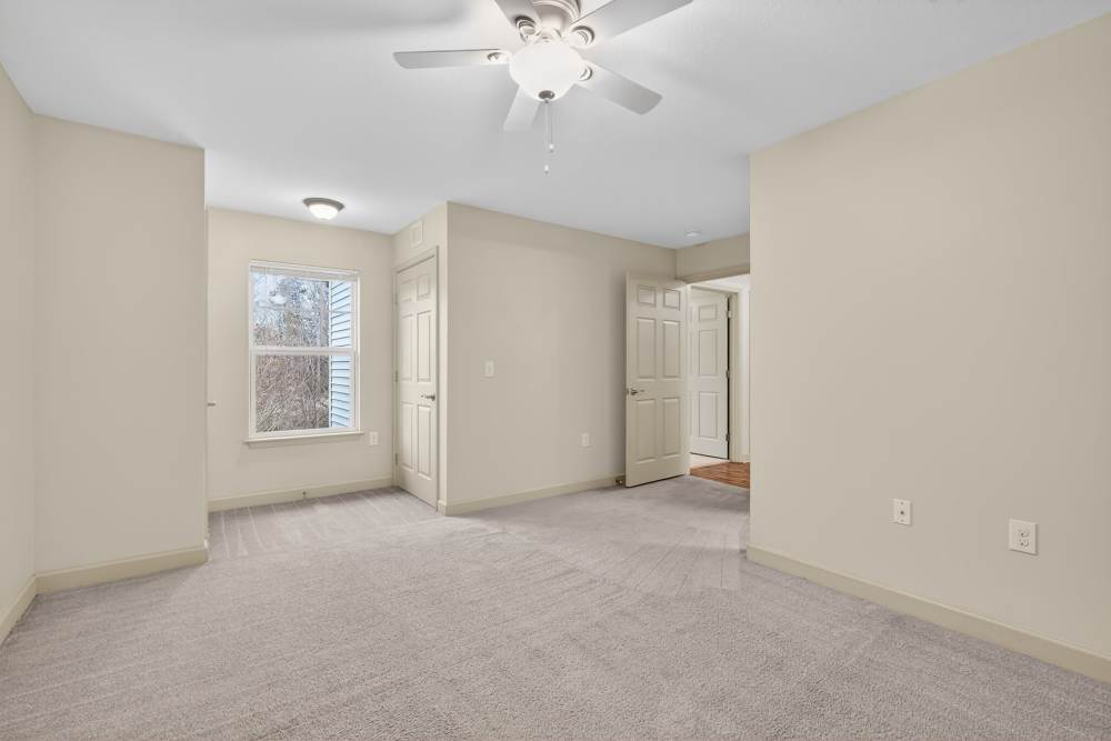 Apartment bedroom with a window at Cooper Creek Heights in Mocksville, North Carolina