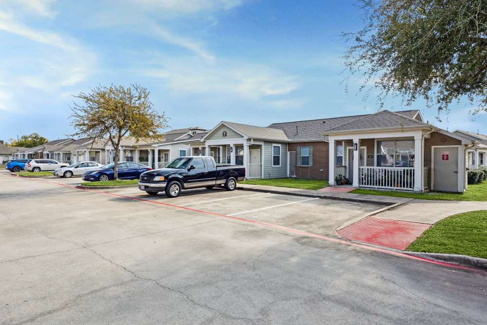 Charming homes with spacious parking and lush green surroundings at Gibraltar Senior in Clute, Texas