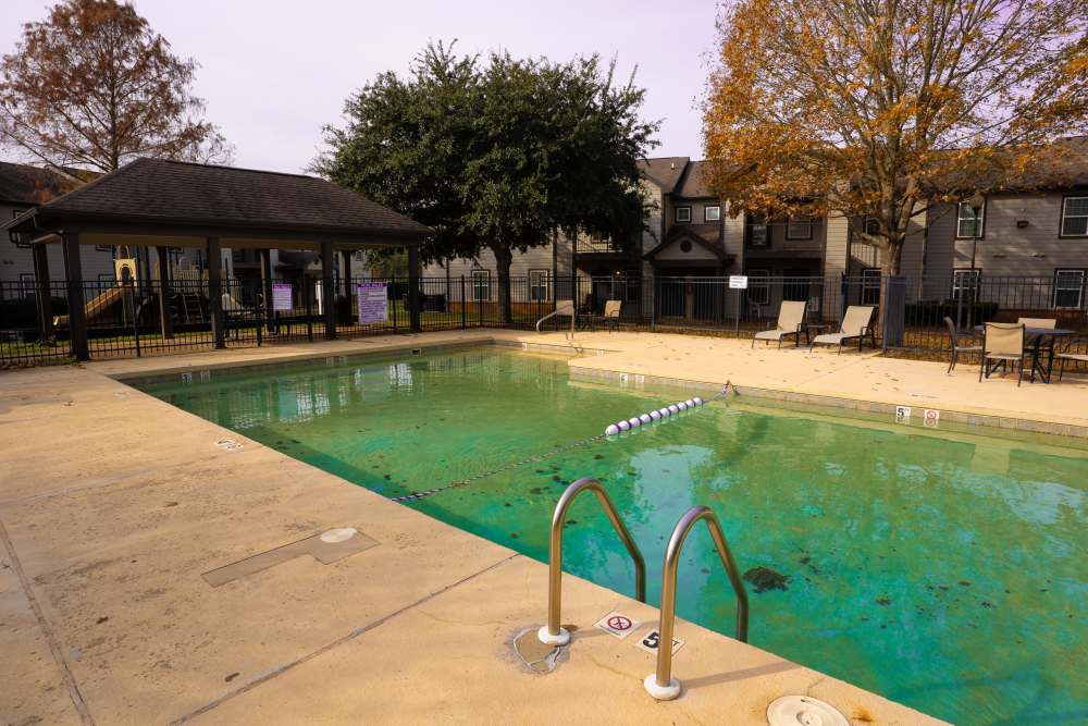 Swimming pool with lounge chairs at Hampton Chase in Palestine, Texas
