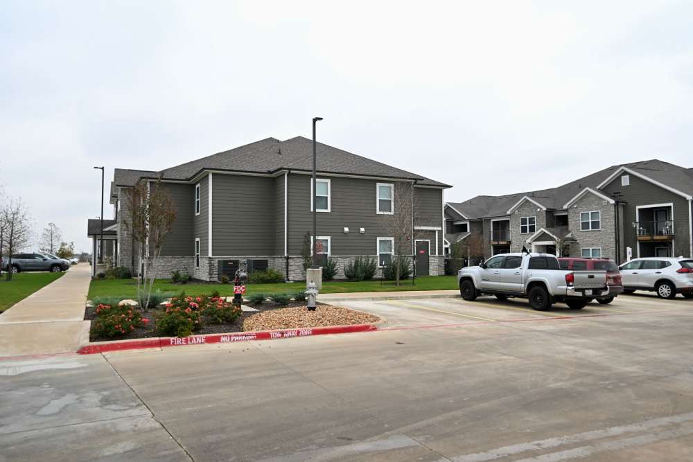 Apartment exterior with parking at Carver Ridge in Hutto, Texas