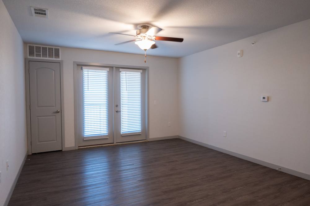 Living room with attached patio at Estates At Rockwell in Oklahoma City, Oklahoma