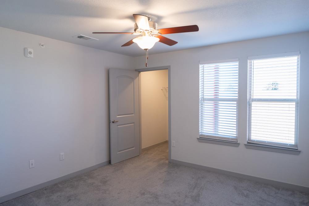 Bedroom with ceiling fan at Estates At Rockwell in Oklahoma City, Oklahoma
