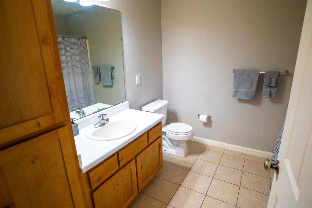 Bathroom with tile flooring and full height cabinet at Hampton Village in Palestine, Texas