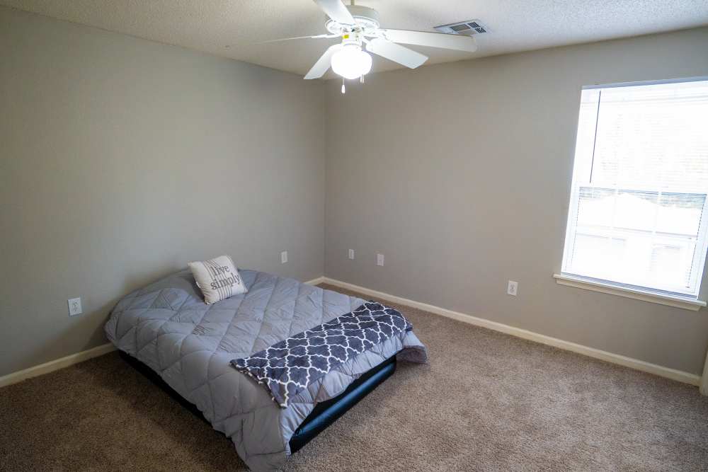 Bedroom with a ceiling fan at Hampton Village in Palestine, Texas