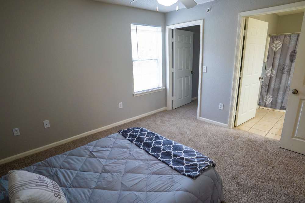 Spacious bedroom with closet and window at Hampton Village in Palestine, Texas
