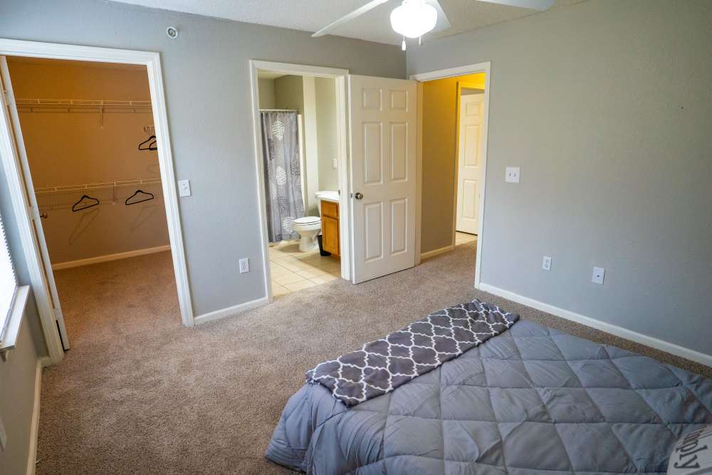 Spacious bedroom with attached closet and bathroom at Hampton Village in Palestine, Texas