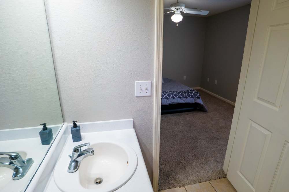 Bathroom entry from bedroom at Hampton Village in Palestine, Texas