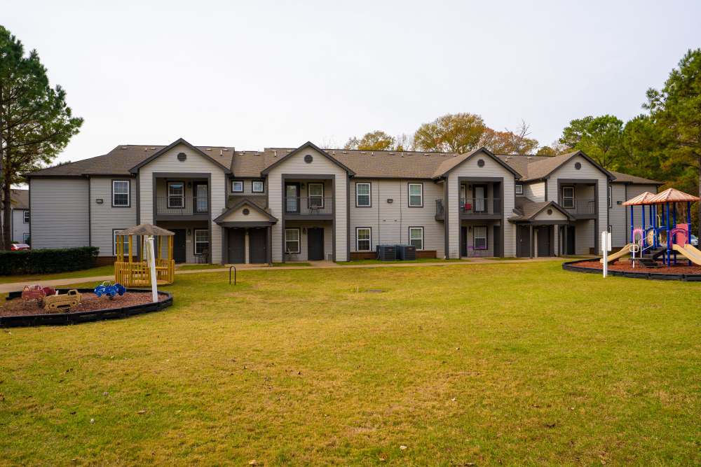 Lawn and playground view at Hampton Village in Palestine, Texas