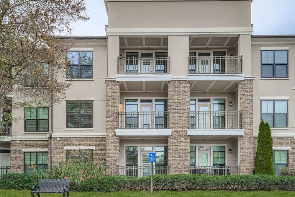 Inviting and elegant sitting area featuring stylish armchairs, a chic round coffee table, and a sleek fireplace at 2370 Main at Sugarloaf in Duluth, Georgia