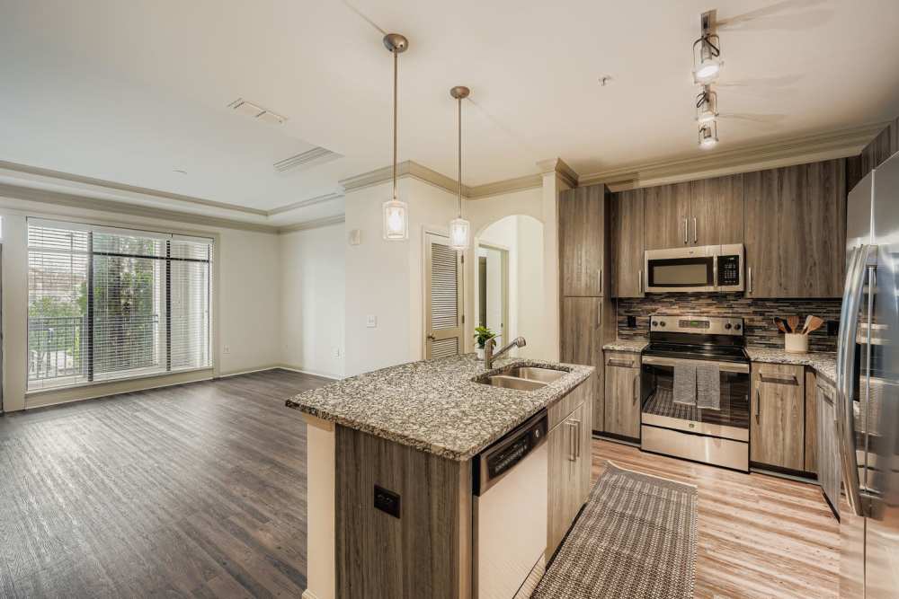 Spacious island kitchen with pendant lights at 2370 Main at Sugarloaf in Duluth, Georgia