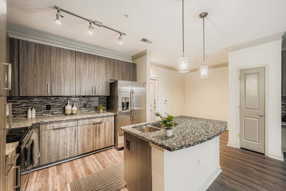 Spacious island kitchen with pendant lights at 2370 Main at Sugarloaf in Duluth, Georgia