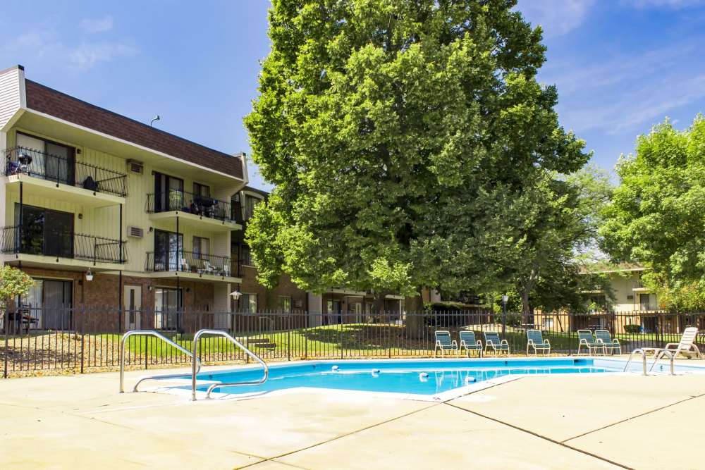 Pool with lounge chair at Broadway Crossing Apartments in Merrillville, Indiana