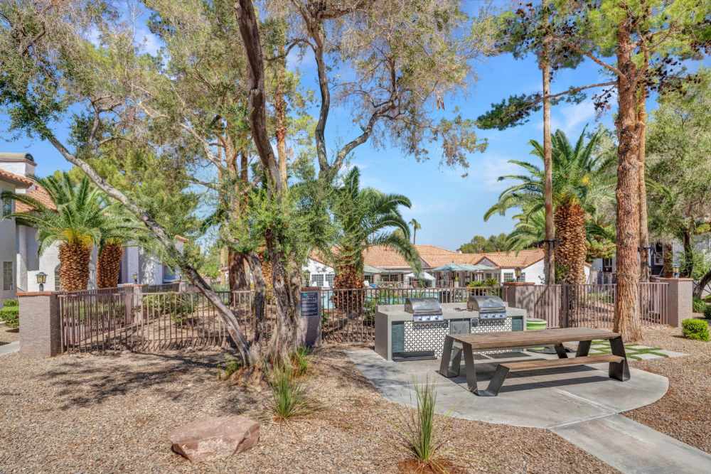 Outdoor seating area with trees at Fairways on Green Valley in Henderson, Nevada