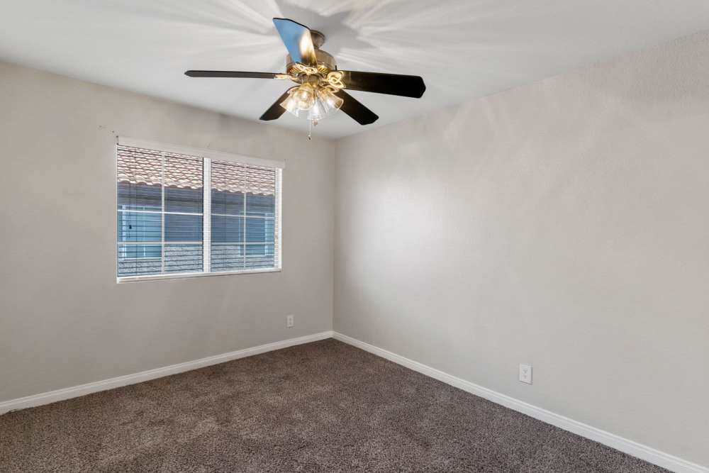 Bedroom with window and fan at Fairways on Green Valley in Henderson, Nevada