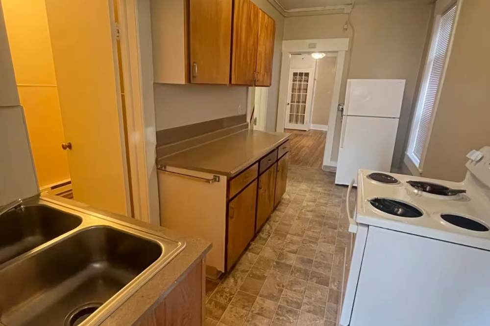 Kitchen with white appliances at Westminster Apartments in Spokane, Washington