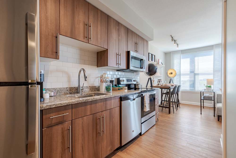 Upgraded kitchen with sleek appliances and cozy dining area at Jefferson Marketplace in Washington D.C., District of Columbia