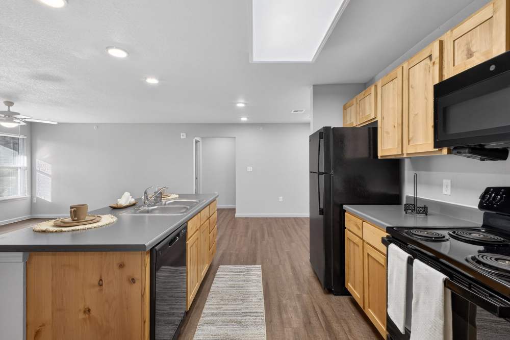 Kitchen with black appliances at Juniper Pointe in Kaufman, Texas