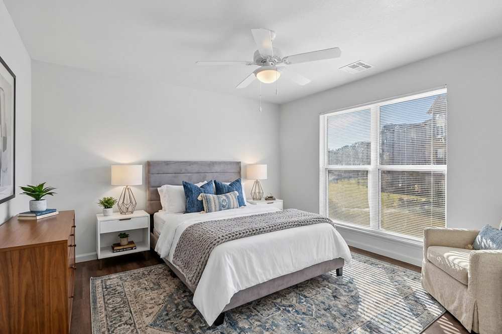 Bright bedroom with large window at Juniper Pointe in Kaufman, Texas