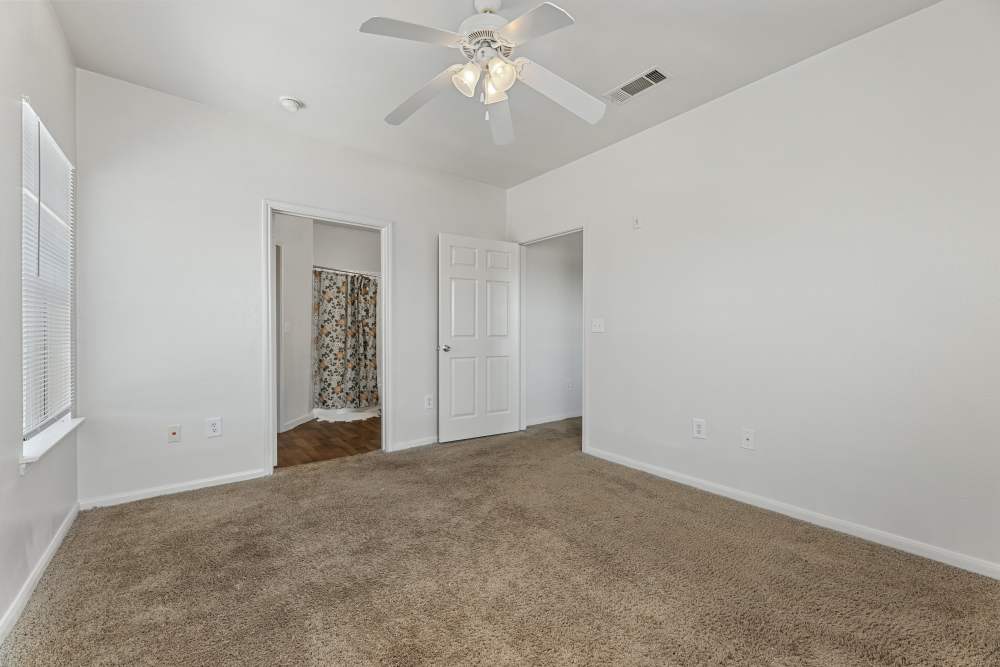 Bedroom with ceiling fan at Knightsbridge in Humble, Texas