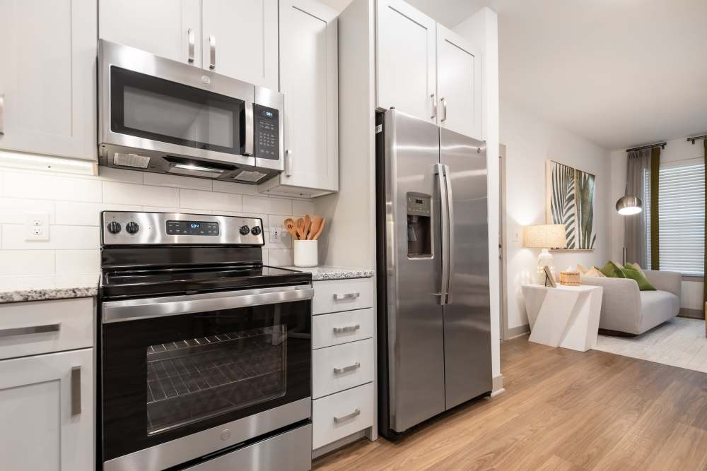 kitchen with microwave, oven and refrigerator